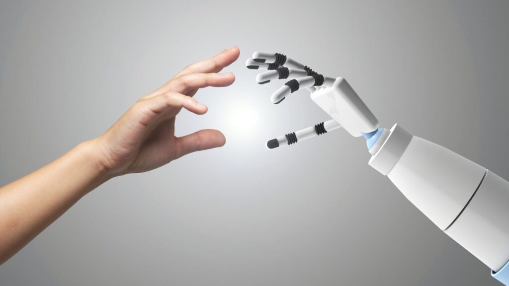 A human hand reaching out to connect with a robotic hand, symbolizing human-AI collaboration, innovation, and the future of technology integration.
