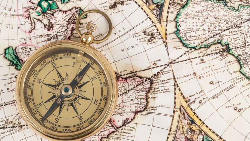 Antique compass on a vintage world map symbolizing navigation and direction—representing global financial control and coordination in Multi-Entity Management with Business Central.
