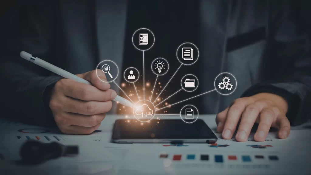 Business professional using a digital stylus on a tablet with cloud computing and workflow automation icons radiating outward, representing modern data integration and digital transformation.