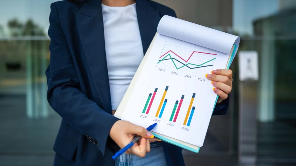 Business professional reviewing performance charts that support Lean Manufacturing through data-driven decision-making and continuous improvement.
